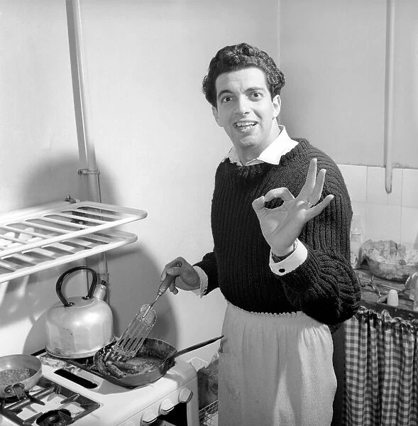 Singer Frankie Vaughan seen here at home cooking breakfast for his family. Circa 1957