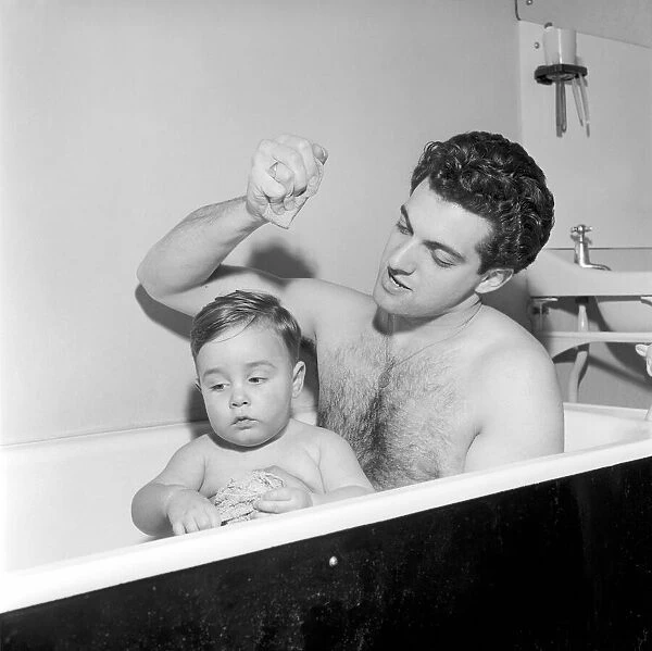 Singer Frankie Vaughan seen here taking a bath with his son David. Circa 1957