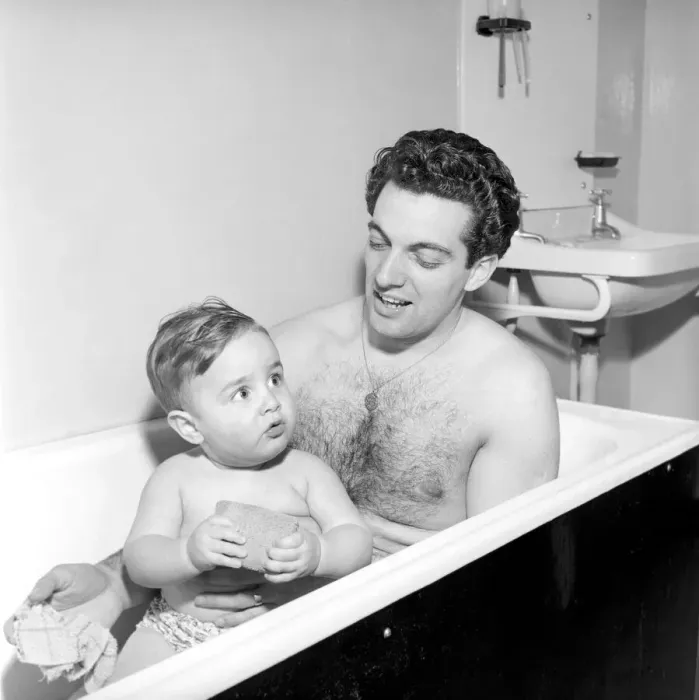 Framed Print : Singer Frankie Vaughan seen here taking a bath with his son David. Circa 1957 Framed Print : Singer Frankie Vaughan seen here taking a bath with his son David. Circa 1957
