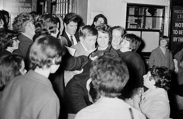Singer Johnny Leyton surrounded by a crowds of girls as he tries to leave the Lyceum