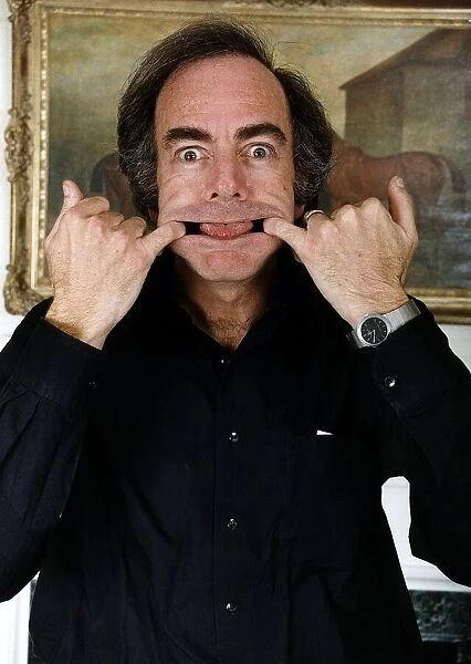 Singer Neil Diamond clowns for the camera during a tour of the UK