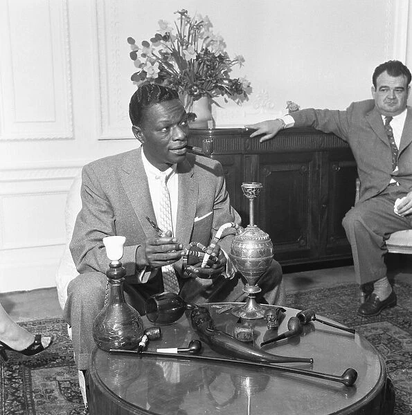 Singer and pipe collector Nat King Cole seen here with his collection of pipes in his