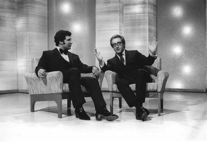 Framed Print : Singer Tom Jones with Actor Peter Sellers on a chat show - Sellers gestures with his Framed Print : Singer Tom Jones with Actor Peter Sellers on a chat show - Sellers gestures with his
