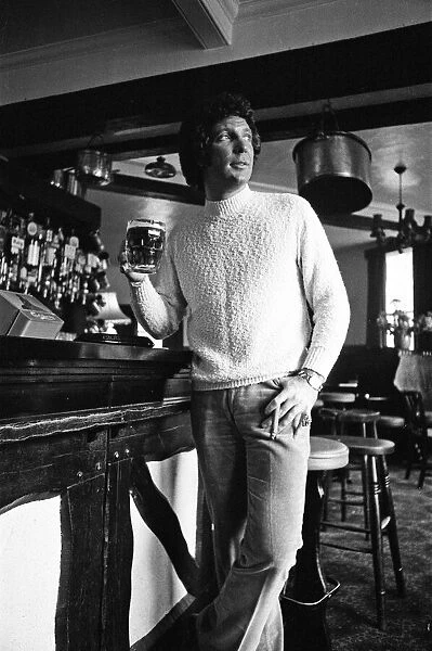 Singer Tom Jones has a quiet drink at his local in Weybridge after missing fans at