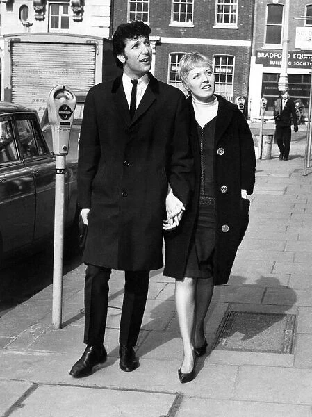 Singer Tom Jones and wife Melinda stroll around Hanover Square in London