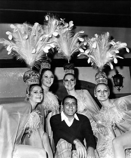 Singer Tony Bennett. poses with the Doriss Girls from the Moulin Rouge in Paris