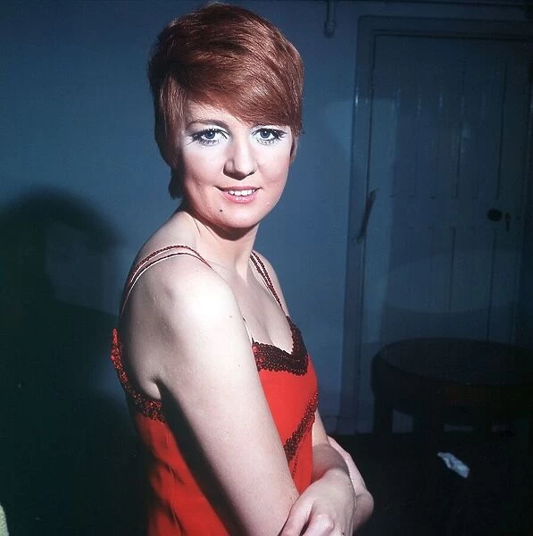 Singer and TV Presenter Cilla Black in low cut red dress