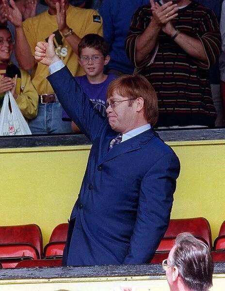 Singer and Watford Chairman Elton John acknowledge the standing ovation from the fans as