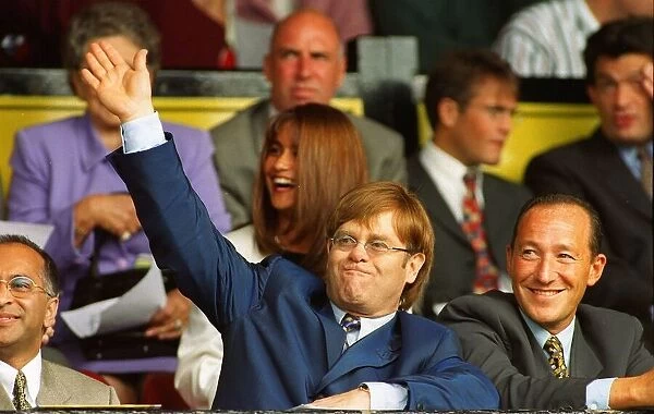 Singer and Watford Chairman Elton John acknowledge the standing ovation from the fans as