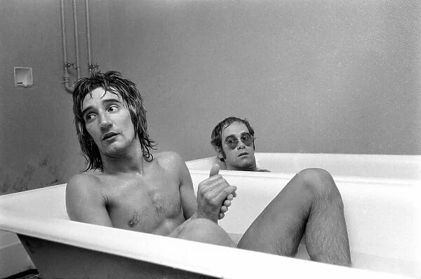 Singers Elton John and Rod Stewart having bath at Watford football ground
