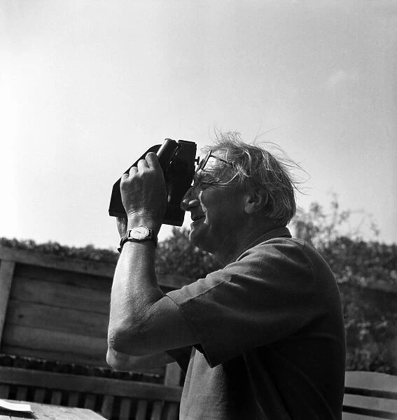 Sir Alan Herbet MP observing planes with his sextant. September 1949 O20122-001