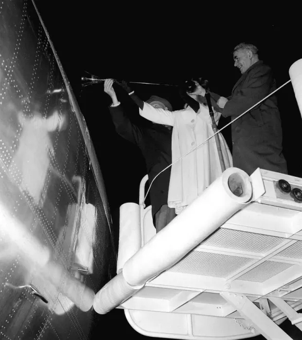 Framed Print : Sir Frank Whittle assisted by Janet Scott christen the first TWA jet aircraft to leave
