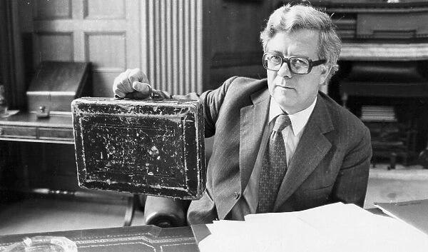 Sir Geoffrey Howe holding up budget box in his office at the Treasury - June 1979
