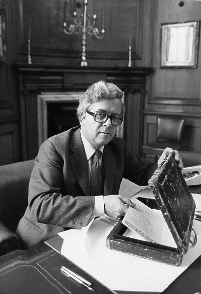 Sir Geoffrey Howe putting speech into budget box in his office at the Treasury - June