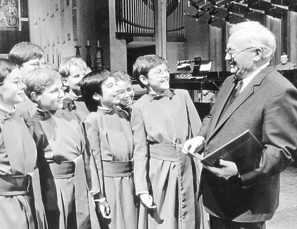 Sir Harry Secombe chats with some of the choirboys during a break in making the TV