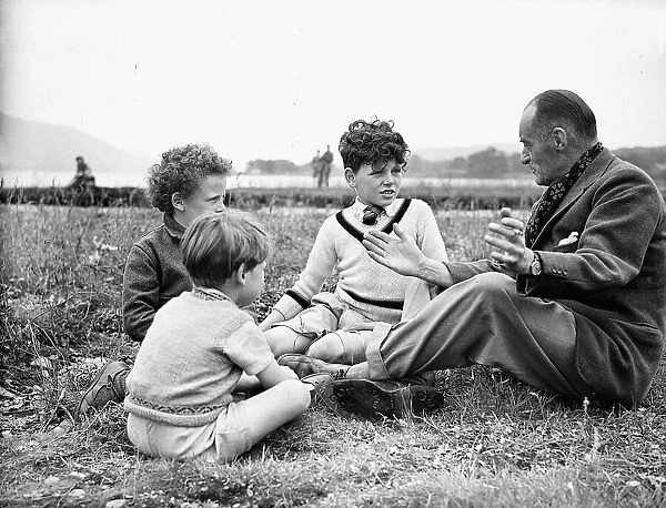 Sir Malcolm Campbell seen here talking to some young admirers inbetween tests he is