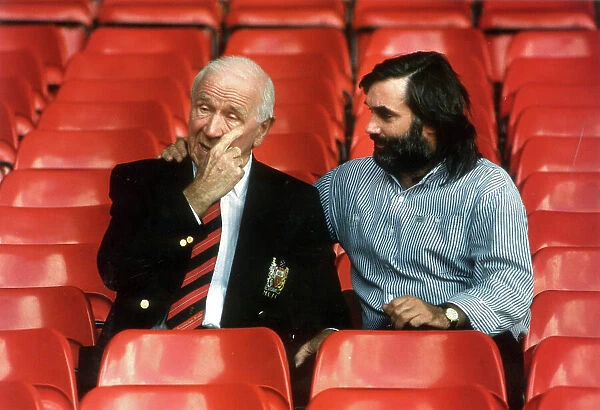SIR MATT BUSBY AND GEORGE BEST SEATED IN FOOTBALL STANDS OF OLD TRAFFORD. 2  /  10  /  90