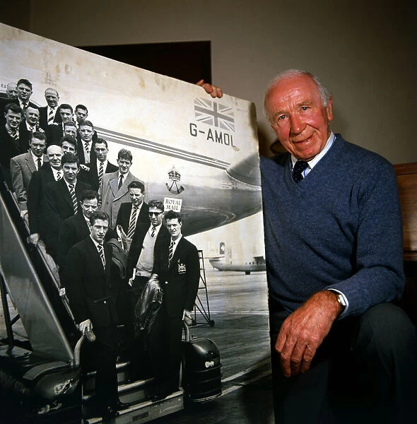 Sir Matt Busby seen here in 1984 with a photograph of the Busby Babes