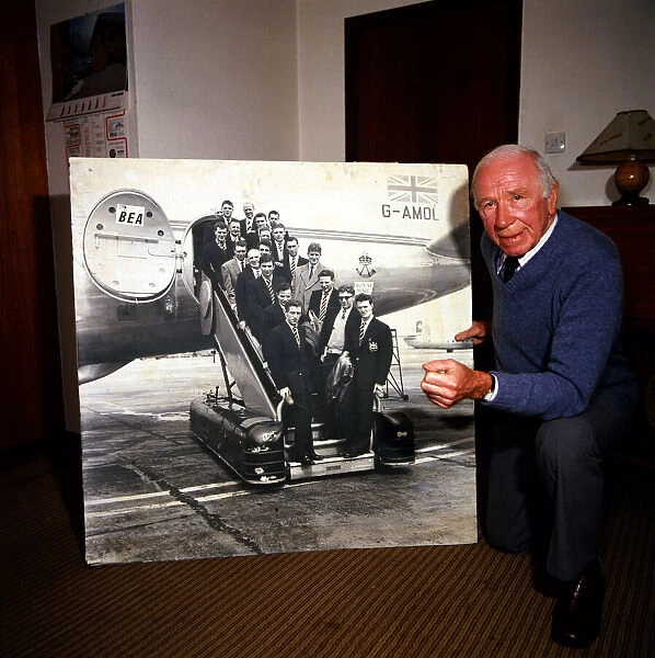 Sir Matt Busby seen here in 1984 with a photograph of the Busby Babes
