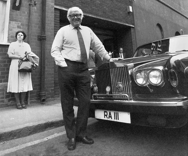 Sir Richard Attenborough leans on the bonnet of a Rolls Royce car