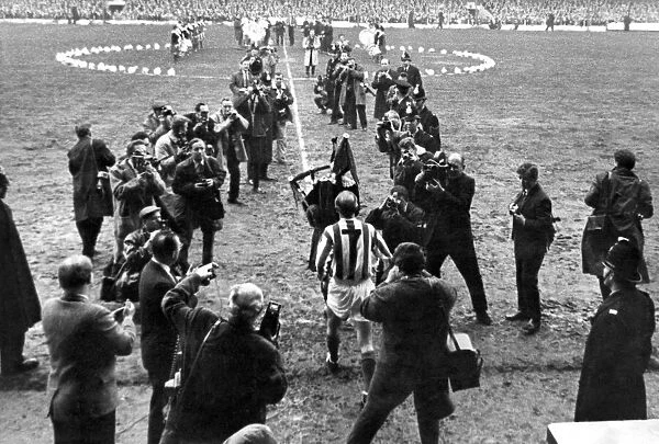 Sir Stanley being piped onto the field. April 1965 P011228