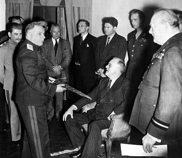 Sir Winston Churchill - December 1943 - Marshal Voroshilov takes the sword over to show