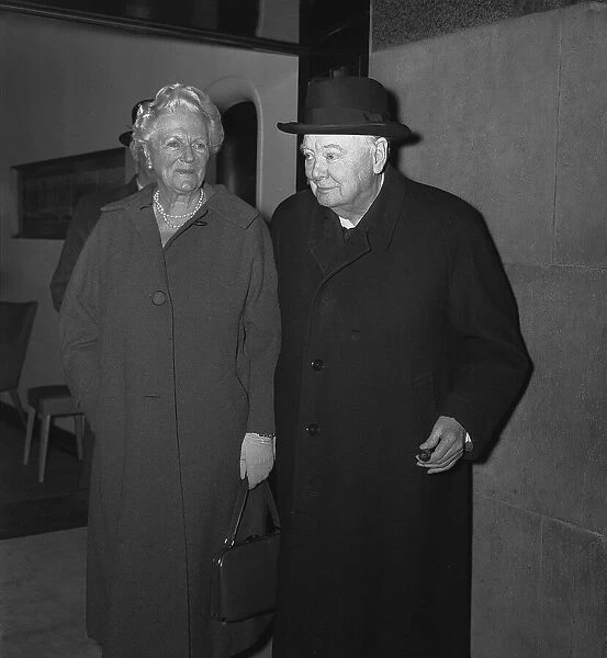 Sir Winston Churchill with his wife Lady Churchill leaving a side entrance of the Savoy