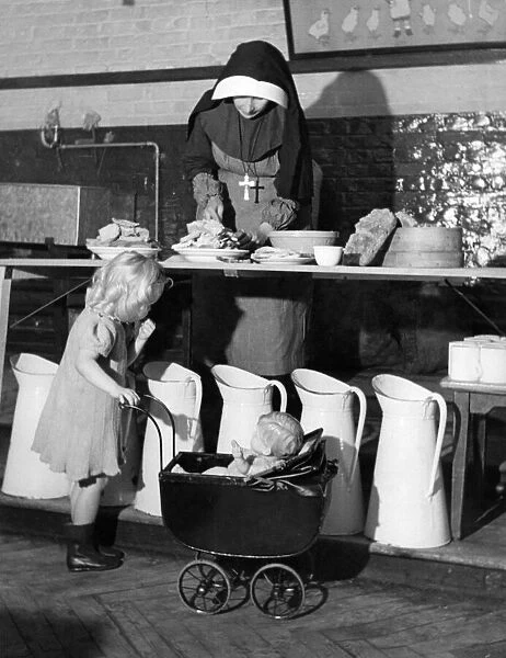 Sister Camillus of St. Anne prepares food at a Convent rest home for bombed Londoners