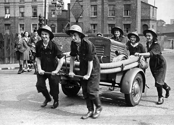 Five sisters form a fire fighting team on a trailer pump and are seen here at practice