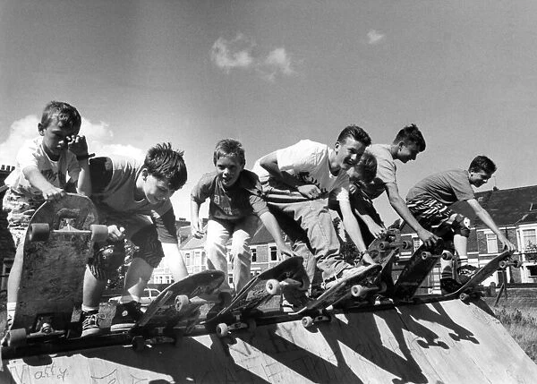 Some skateboard riders prepare for action on the ramp on 17th August 1989