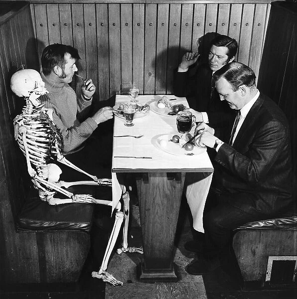 Skeleton sits at table in pub waiting to be served