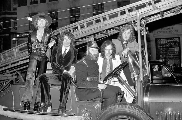 The Slade pop group on fire engine. L to R Dave Hill, Don Powell, Jimmy Lea, Noddy Holder
