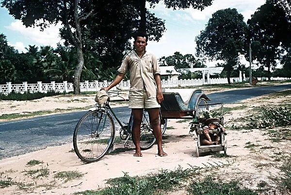 Sleeping child and bicycle rickshaw driver near Angkor Wat North West Kampuchea Cambodia