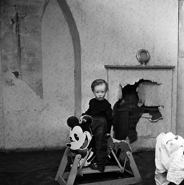 Slum housing in Salford. Three year old John Logan. 3rd April 1960