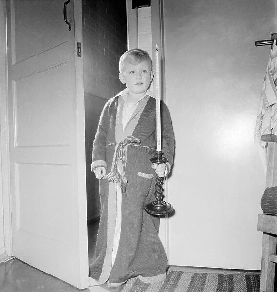 A small boy holding an advent calander candle. November 1953 D6818