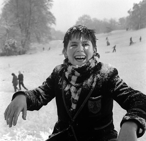 A small boy playing in the snow on Hampstead Heath, New Years Day 1962