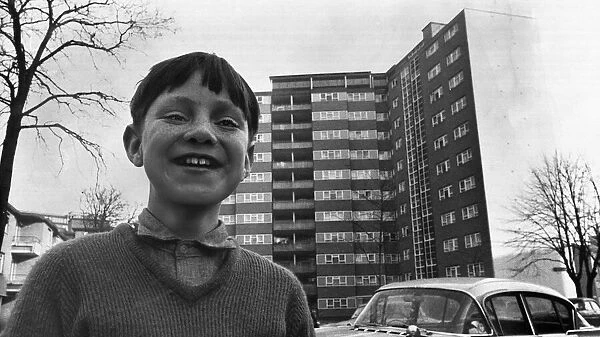A small boy plays outside a block of flats in Stockwell South London Image used