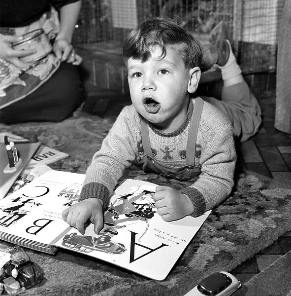 Small boy reading book. Gerry Michael (2) - Car Expert. November 1952 C5495
