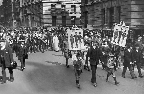Two small boys carrying banners with the message from Lord Roberts '