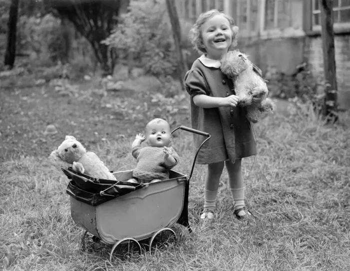Framed Print : Small girl with doll pram buggy push chair Framed Print : Small girl with doll pram buggy push chair