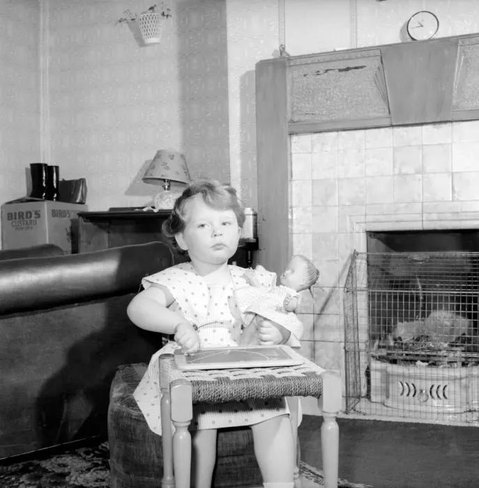 Framed Print : Small girl drawing beside the fireplace: Betty Hampson 36 month old school girl