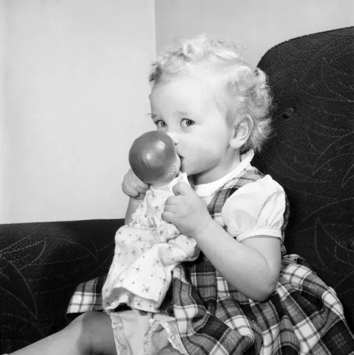 Framed Print : Small girl reading her book also seen with her dolls and violin. 1955 A138-001 Framed Print : Small girl reading her book also seen with her dolls and violin. 1955 A138-001