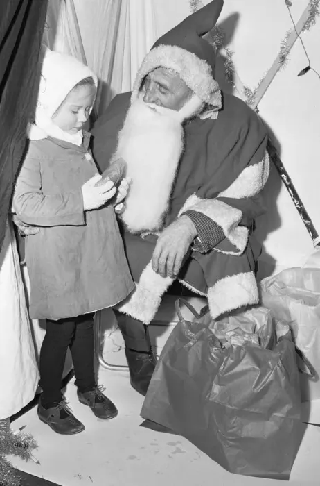 Framed Print : A small girl receives a present from Father Christmas at Woodley 18th November 1966