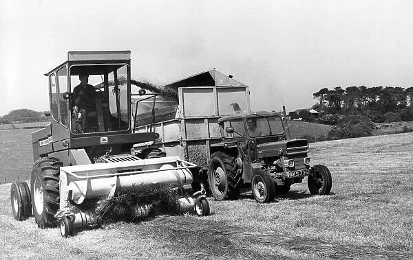 A small grass cutter harvesting some cattle feed on a farm in the 1970s
