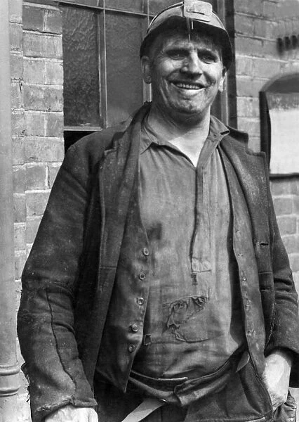 A smiling miner at the end of his shift August 1947 P018212