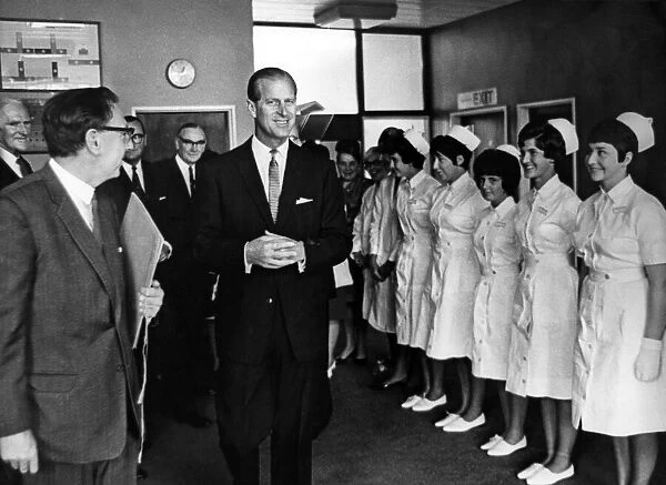 A smiling Prince Philip and smiling nurses as he leaves the Dental Hospital