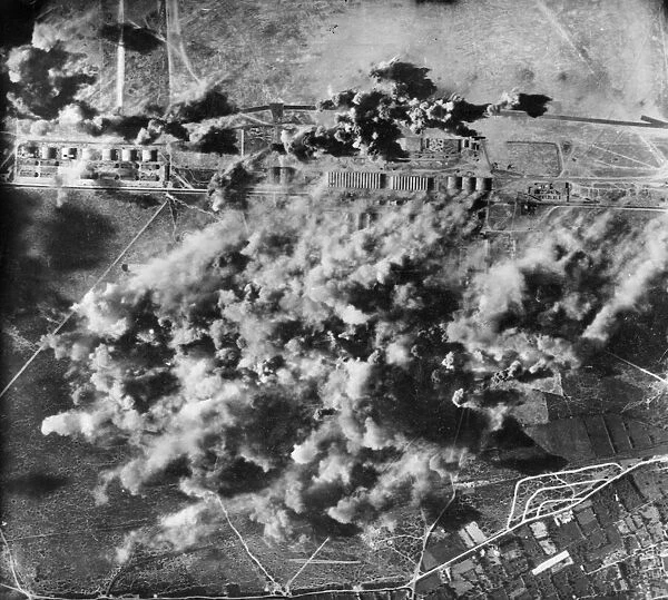 Smoke and dust billow upward during a successful attack by by Flying Fortresses of the US