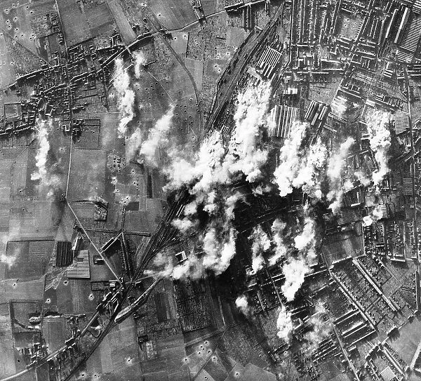Smoke rises from the steel & engineering works at Lille in France during WW2 bombing raid