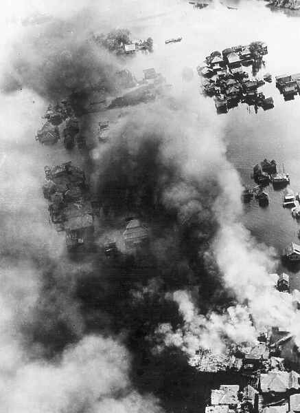 Smoke rises from the town of Brunei in British North Borneo after an attack by RaF