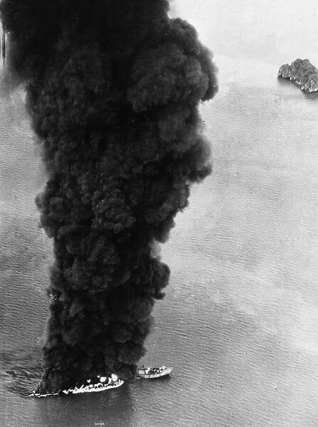 Smoke rising from a 10, 000 ton Japanese tanker which was attacked by Liberators of 159